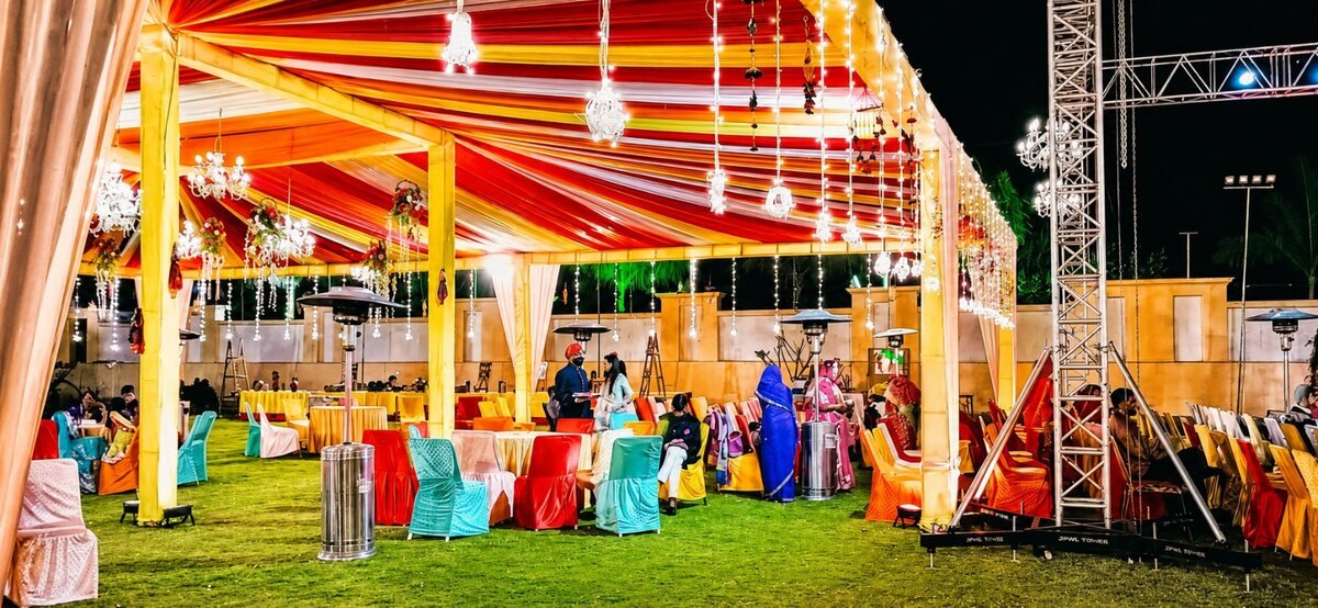 A decorated mandap on the open lawn for a wedding