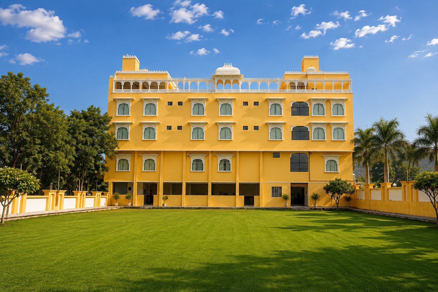The 20,000 sq ft green lawn at Dream Hills Resort with hills in the distance