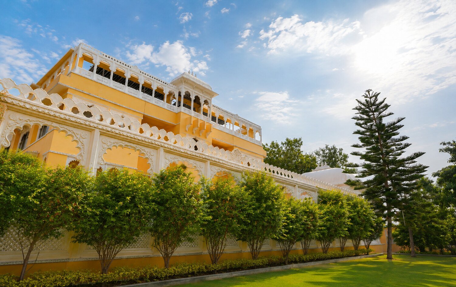 The palace-style facade of Dream Hills Resort beside its swimming pool