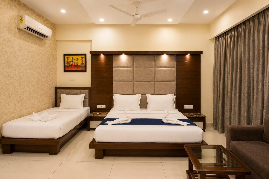 Premium Triple Room interior with wardrobe and TV