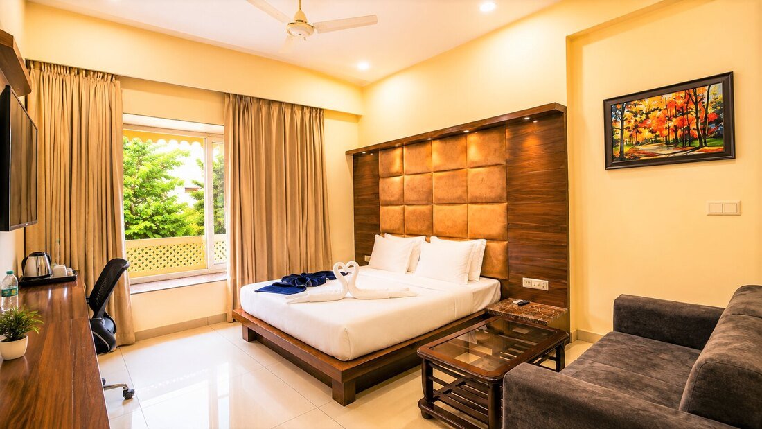 Spacious Superior Deluxe Room with sofa and large headboard